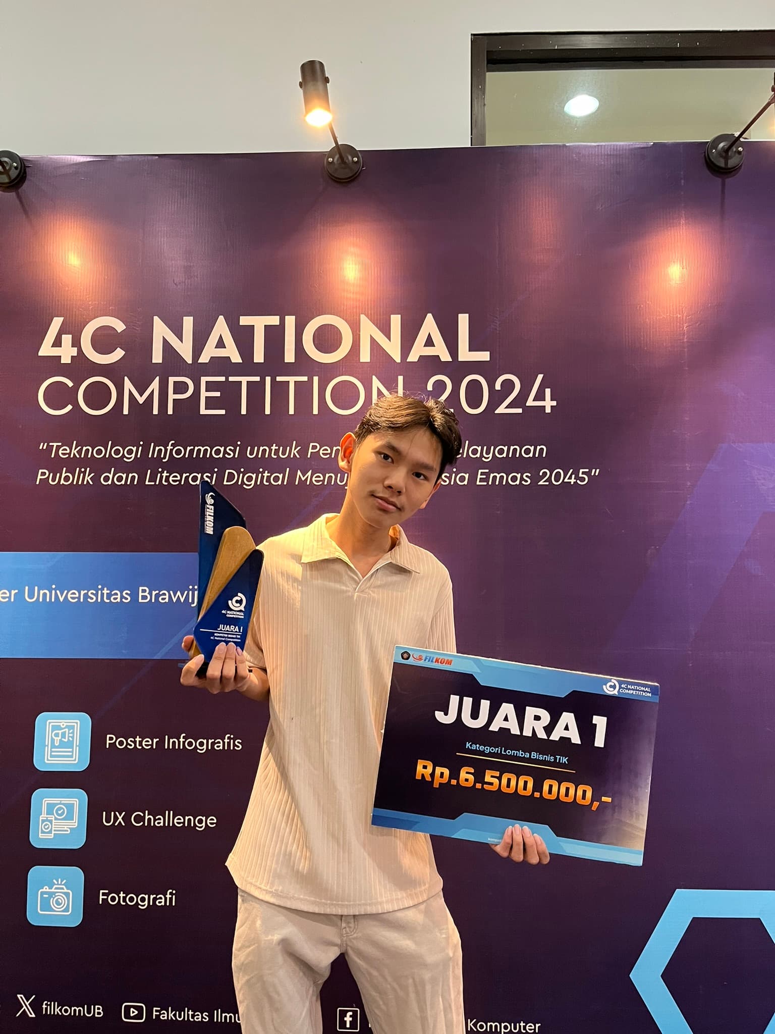 Richard holding a first-place trophy at the 4C National Competition